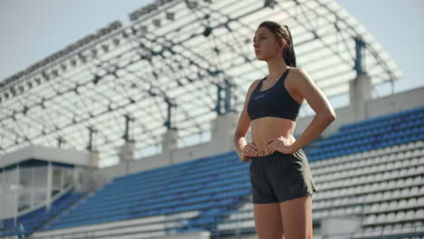 Slow-motion:-woman-athlete-waits-for-start-of-race-in-400-meters.-girl-athlete-waits-for-start-of-race-in-100-meters-during.-Running-at-the-stadium-from-the-pads-on-the-treadmill